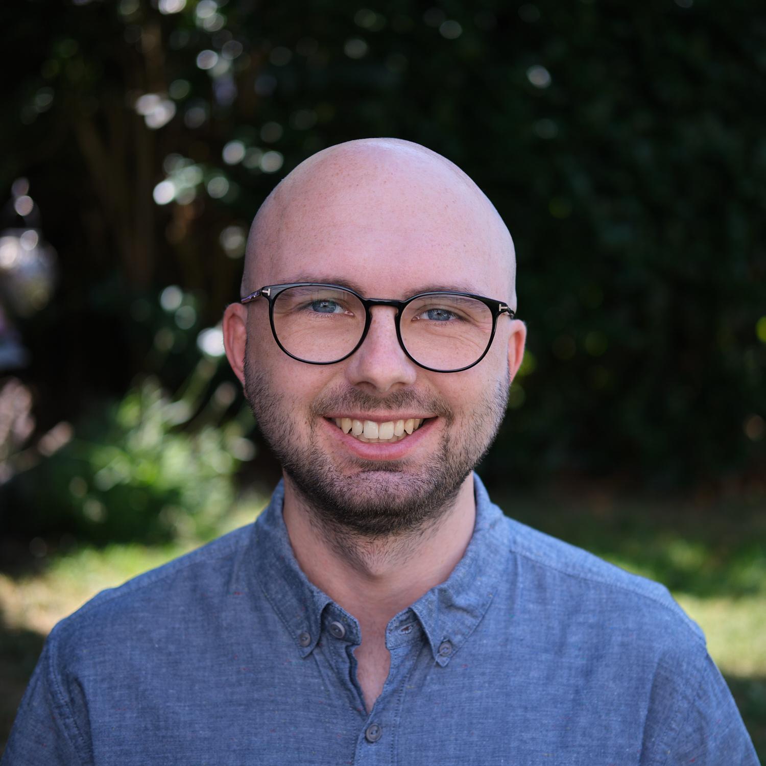Me in a blue t-shirt in front of the beautiful alpes in austria